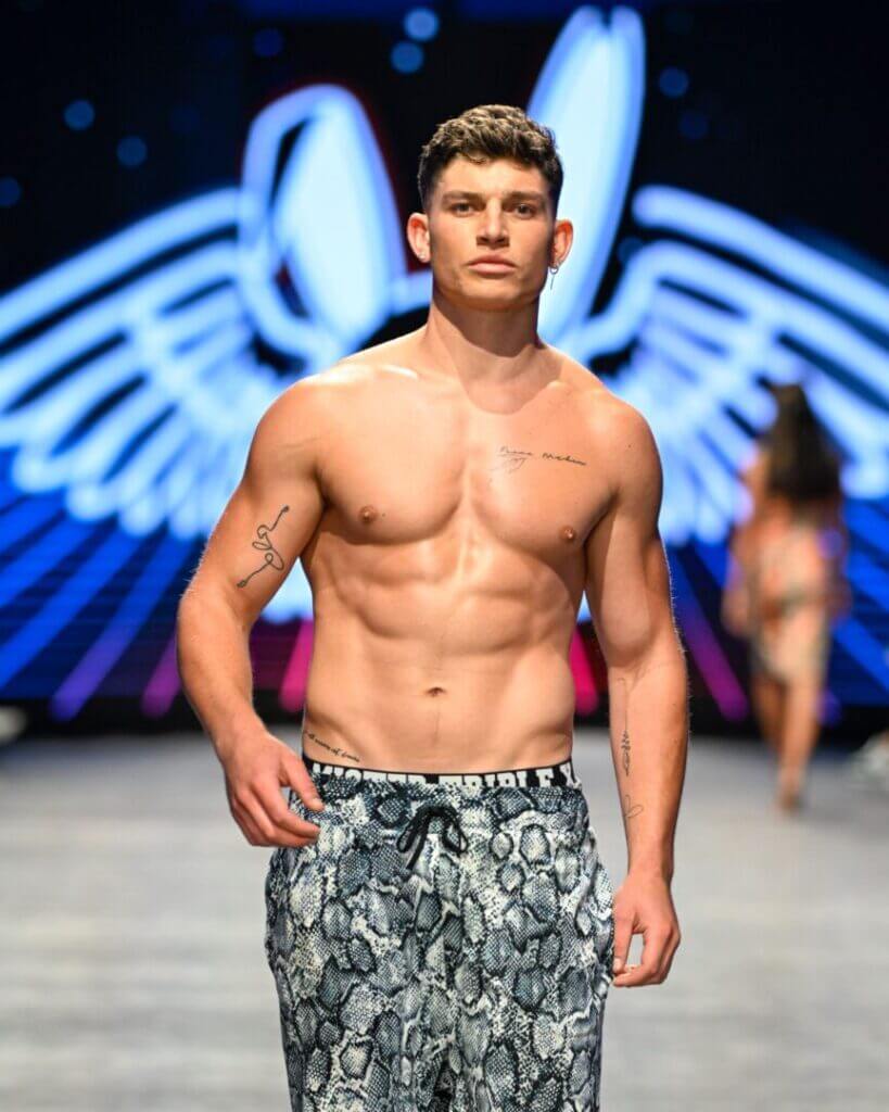 Model in swim shorts at Miami Swim Week