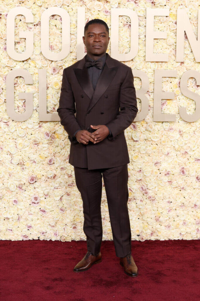 Man in a brown suit at the Golden Globes