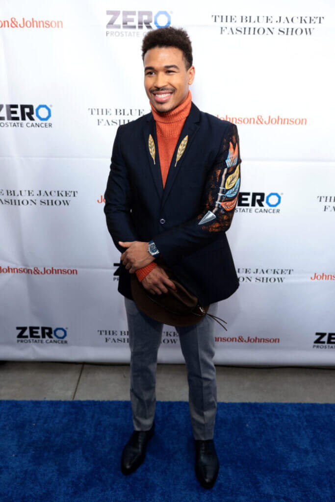 Brian Ceballo holding an award on a red carpet