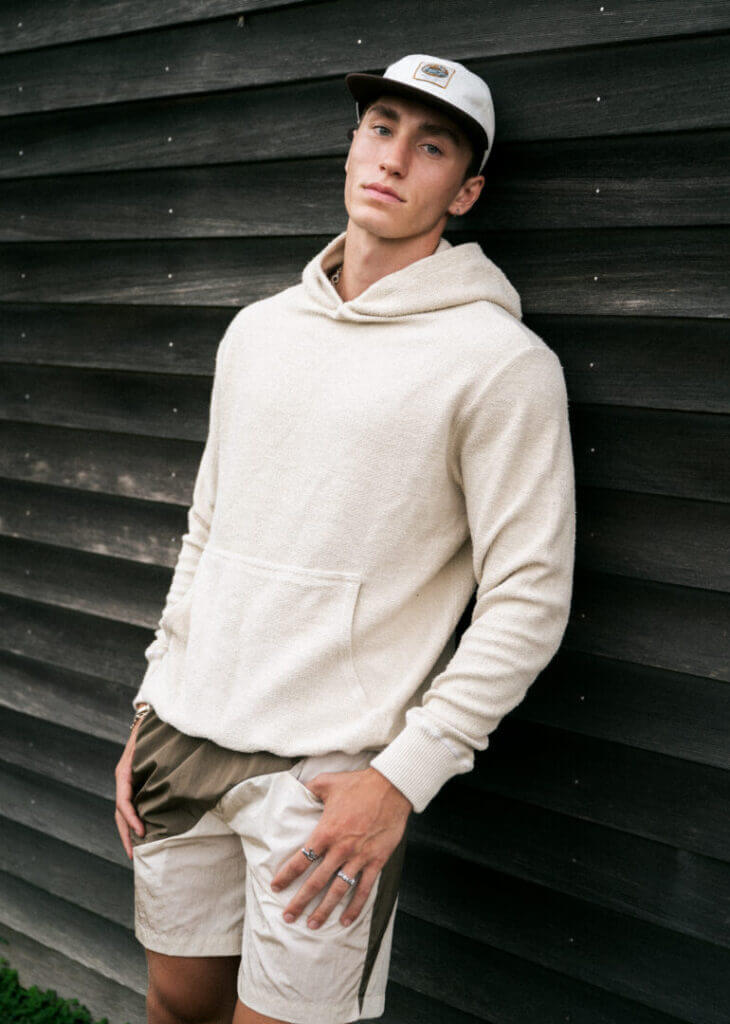 Man in a cap and cream sweatshirt
