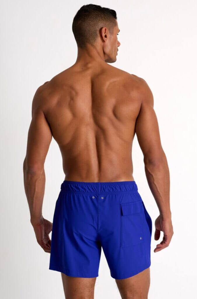 Man in blue swim shorts seen from behind