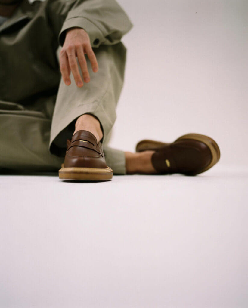 Man's foot in brown loafers