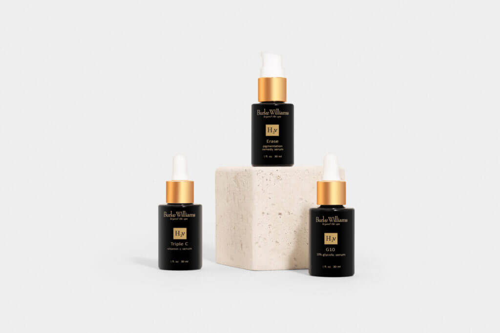 Black and gold fragrance bottles on pedestals