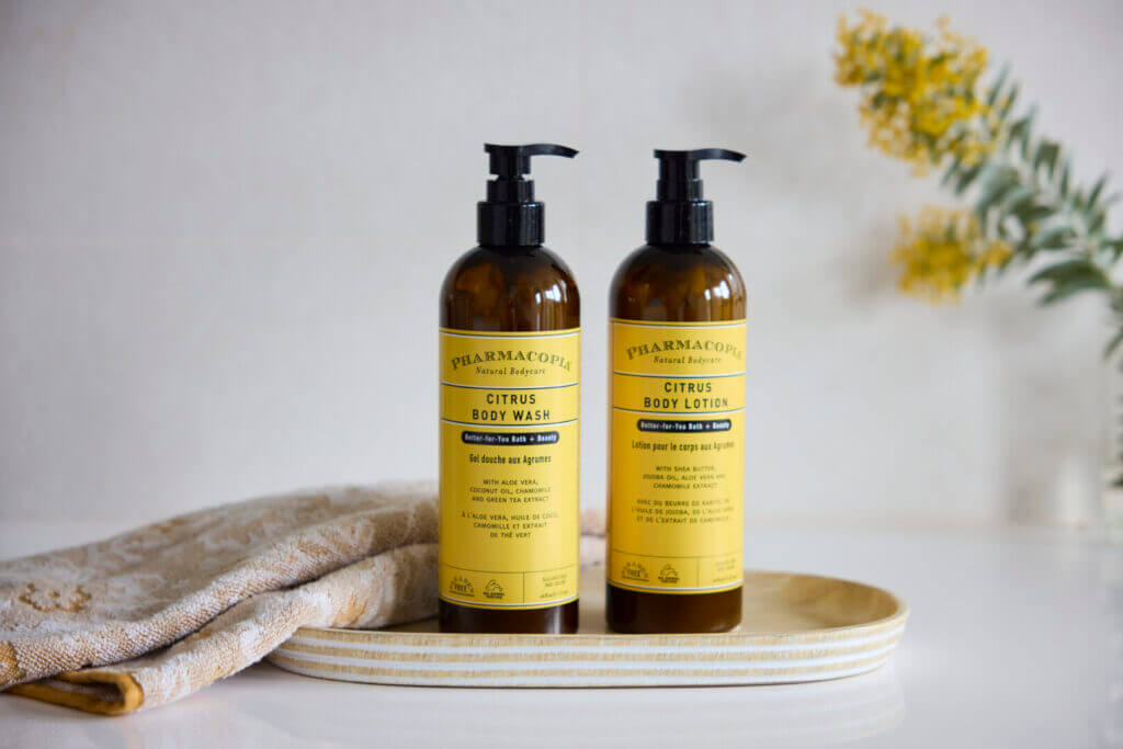 Citrus body care bottles on a tray