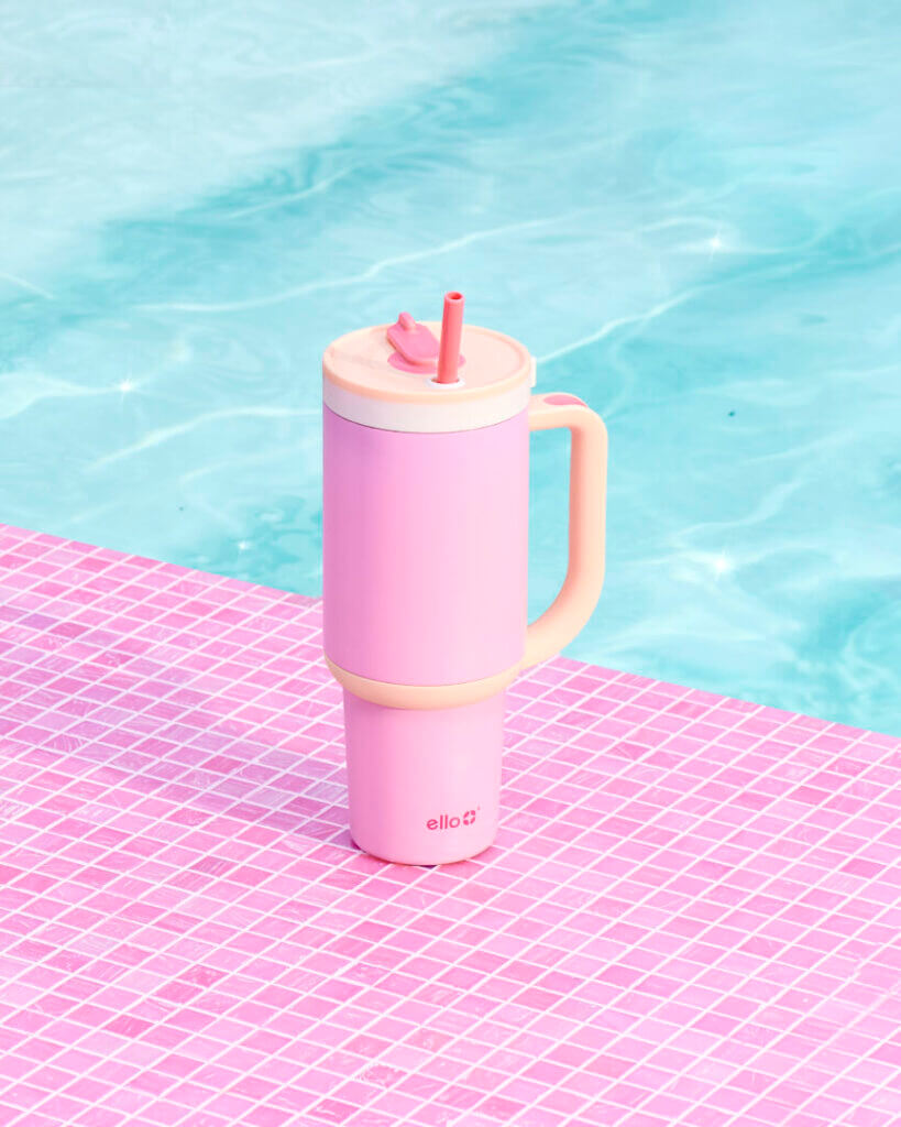 Pink tumbler by a pool