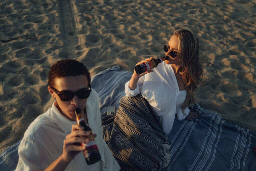 Couple drinking on a picnic blanket