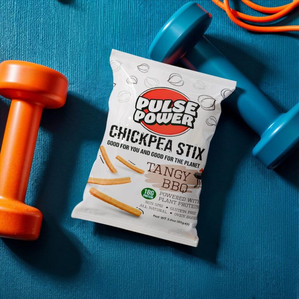 Bag of chickpea sticks beside dumbbells