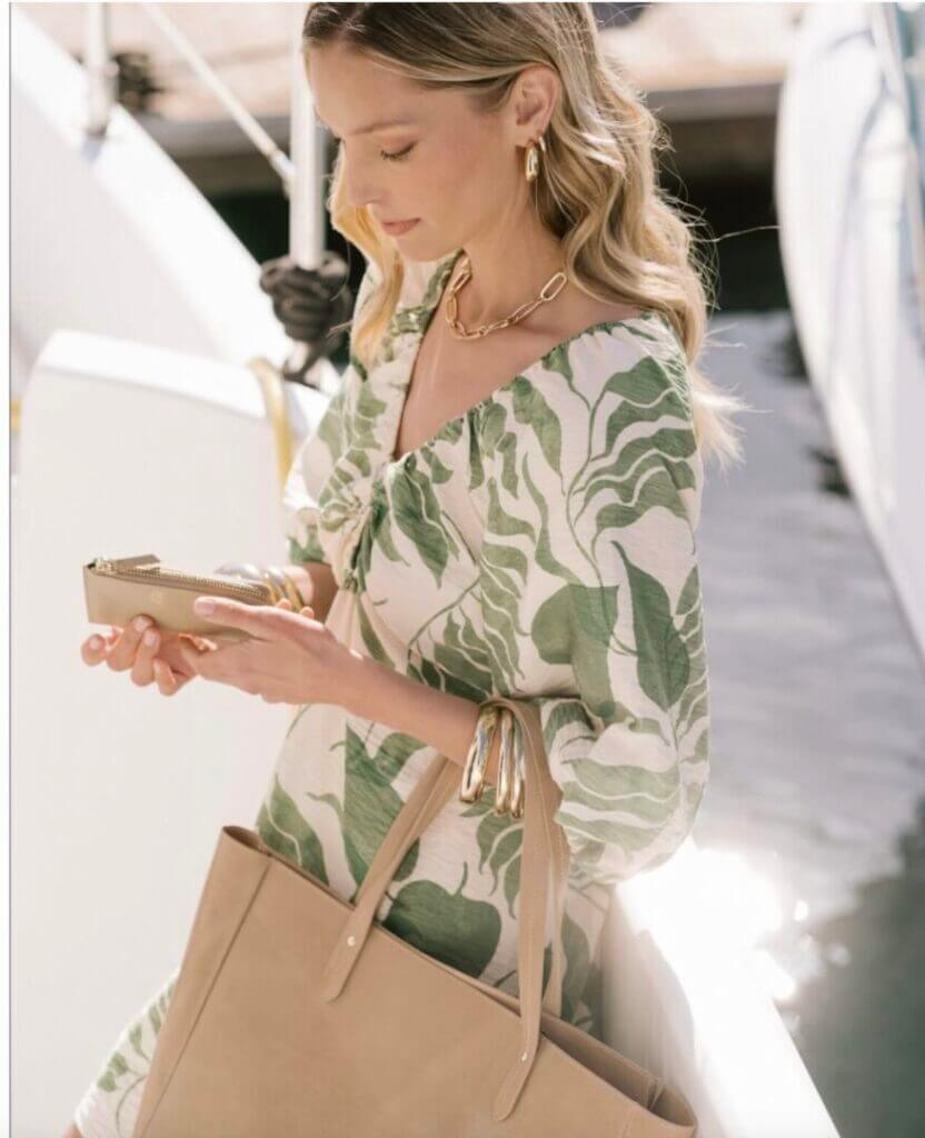 Woman in a floral dress with a tote