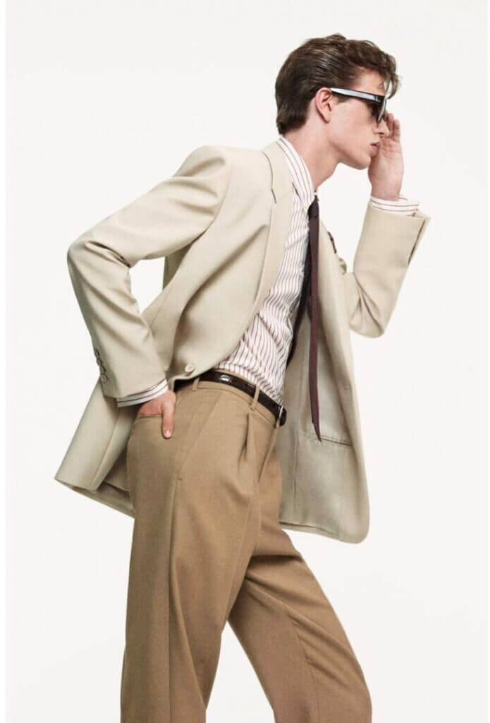 Man in a beige suit and sunglasses