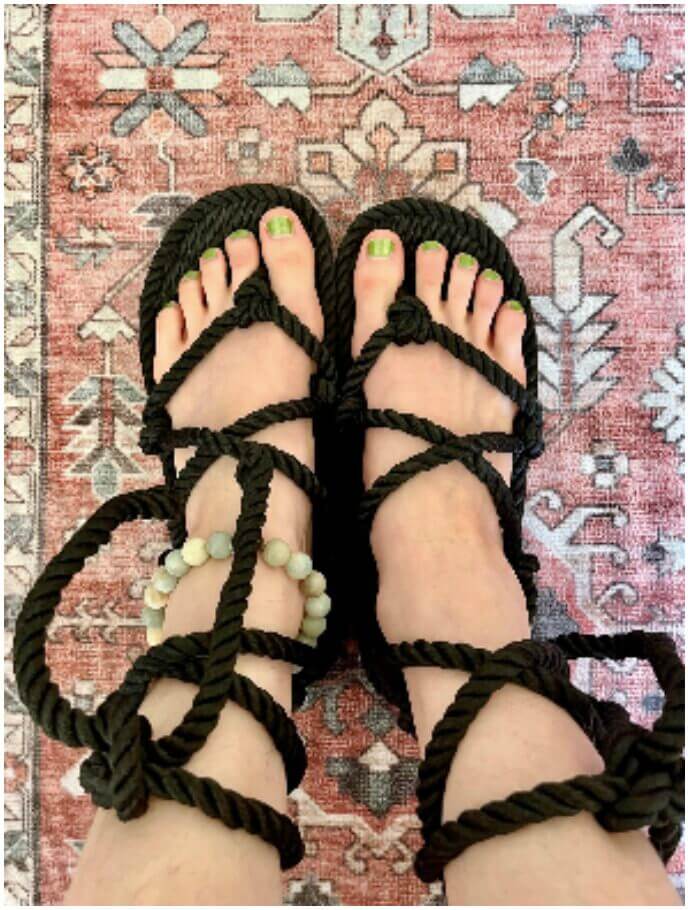 Black rope sandals on a rug