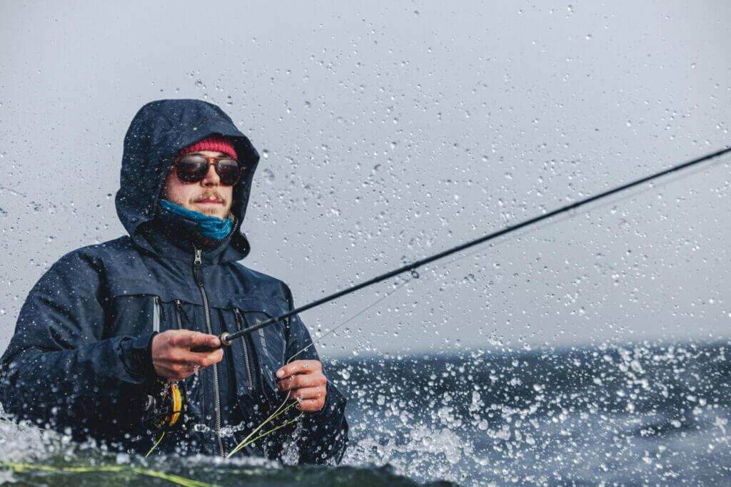 Angler in a rain jacket fishing