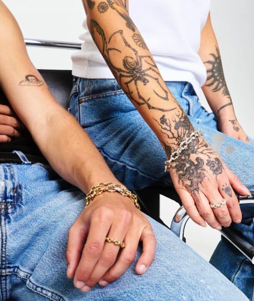Tattooed arm wearing rings