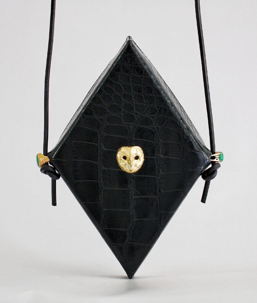 Black diamond-shaped bag with a gold clasp