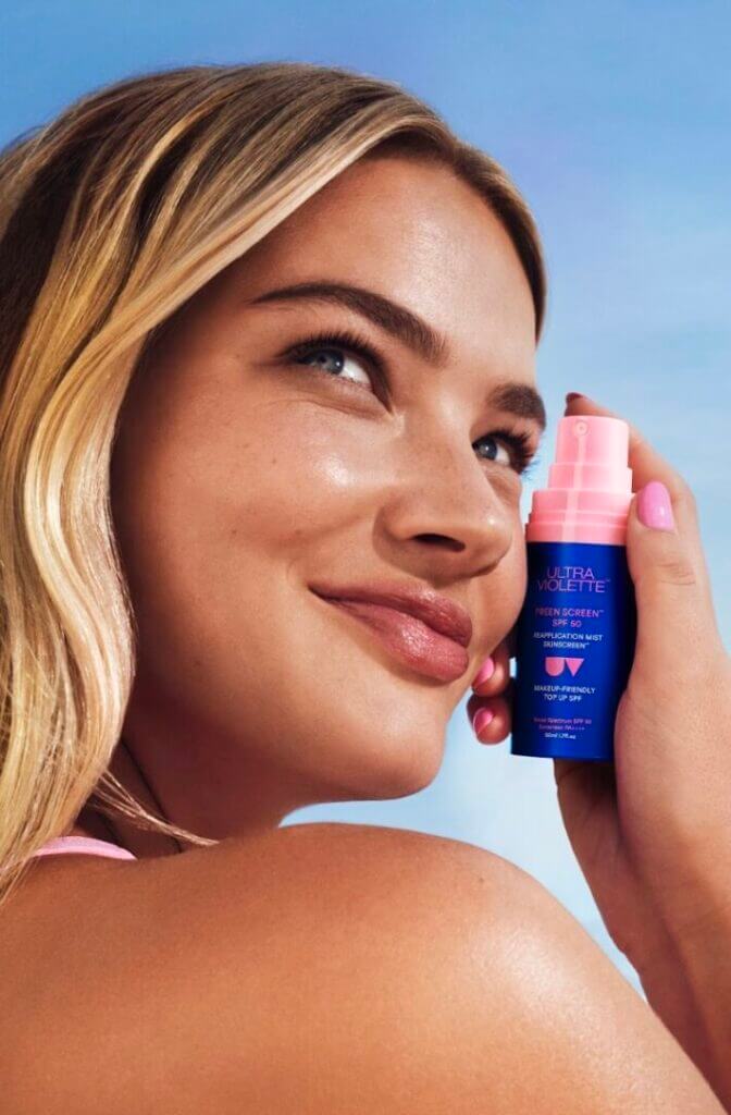 Woman holding a sunscreen bottle