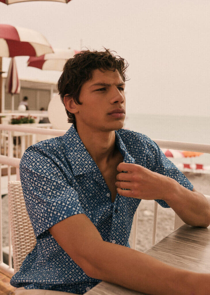 Man in a printed shirt seated