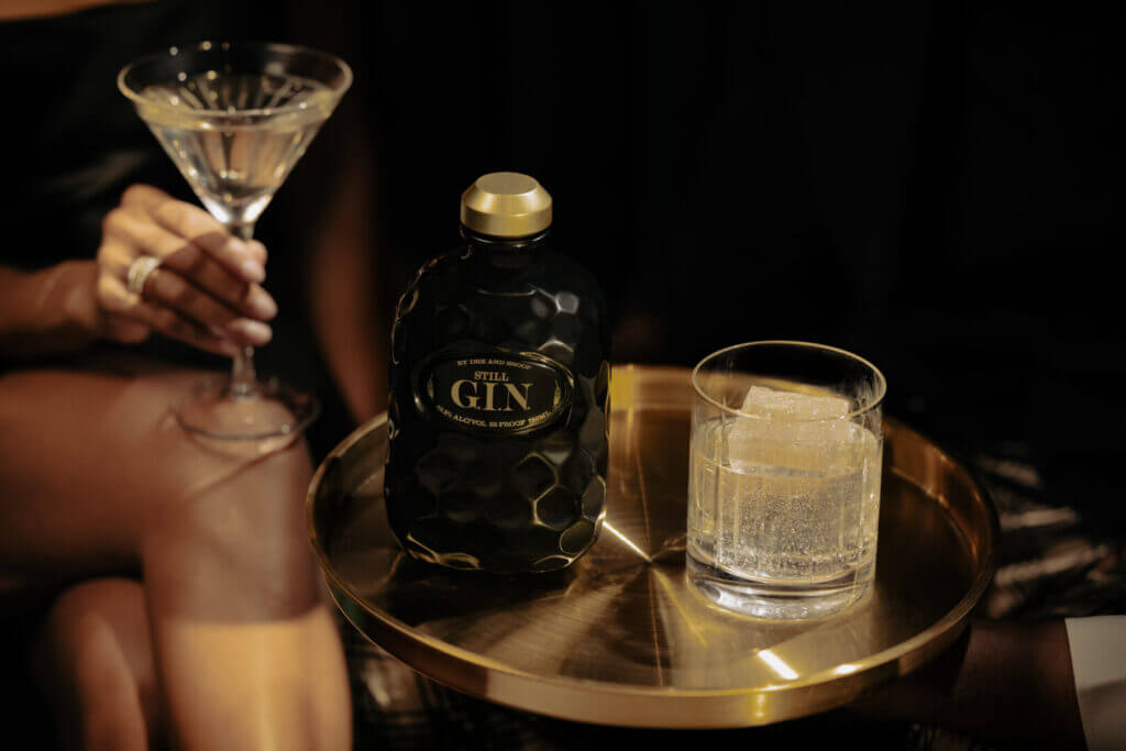 Gin cocktail and bottle on a table