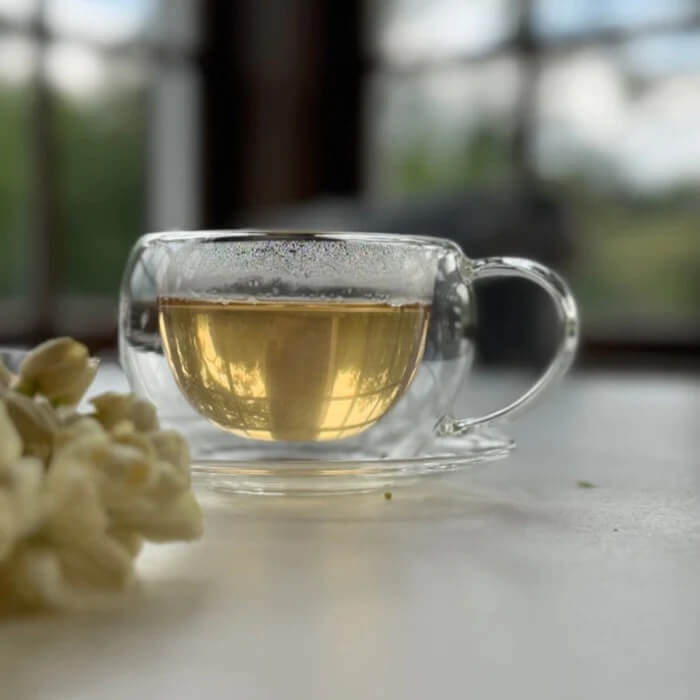 Glass teapot and cup of tea