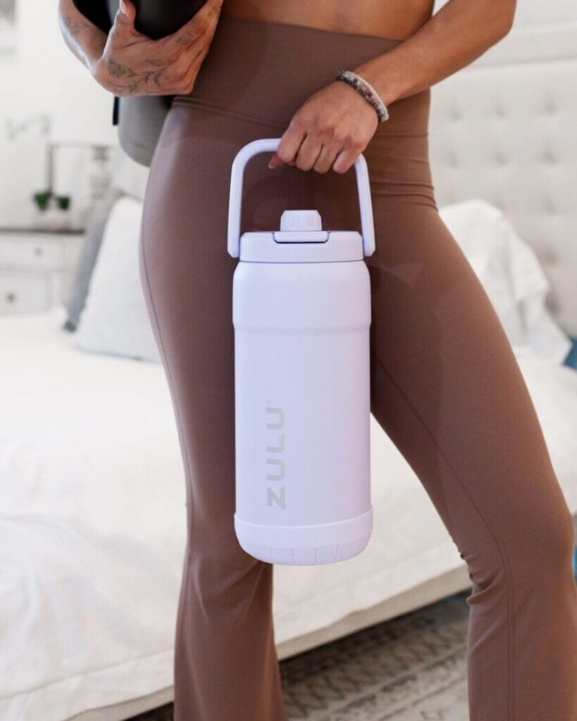 Woman carrying a white water bottle